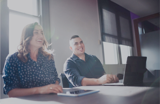 Two administrators working through Tickbox together at a desk